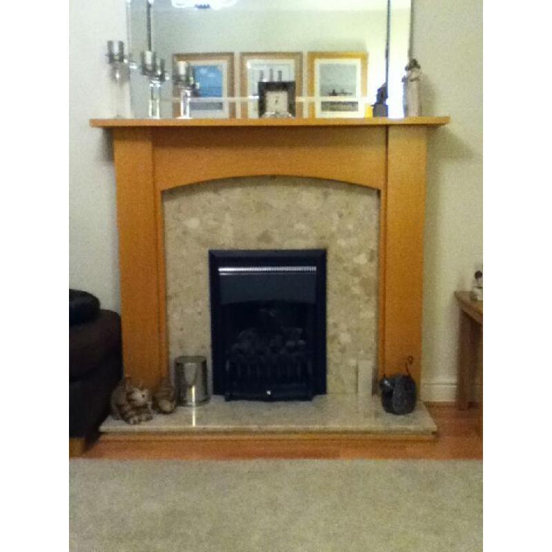 Beech coloured fire surround with marble back and hearth.