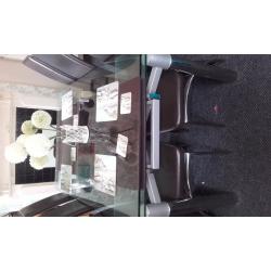 glass extendable dining table and six chairs