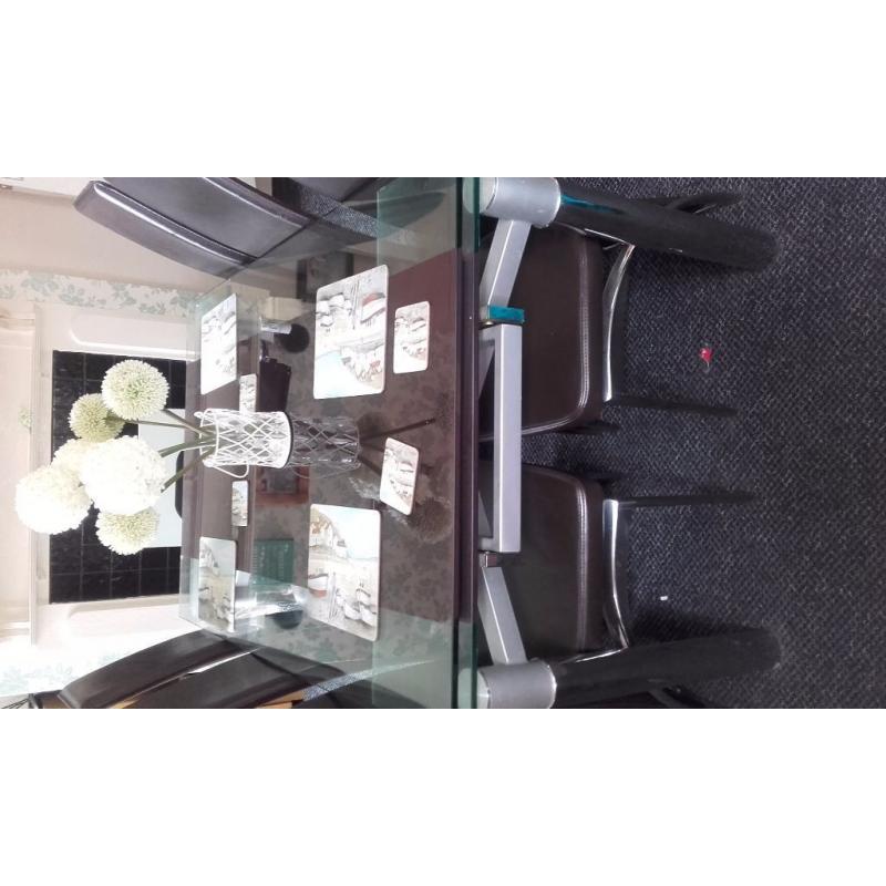 glass extendable dining table and six chairs