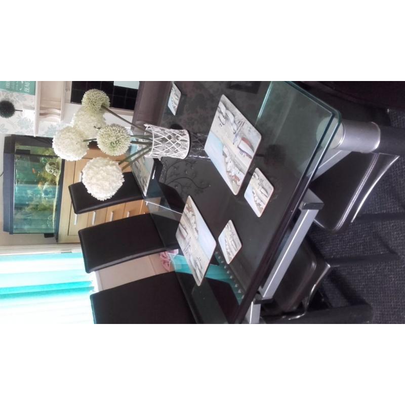 glass extendable dining table and six chairs