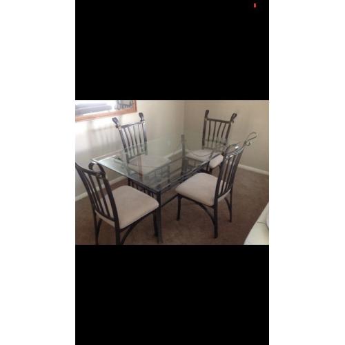 Glass dining table and four chairs
