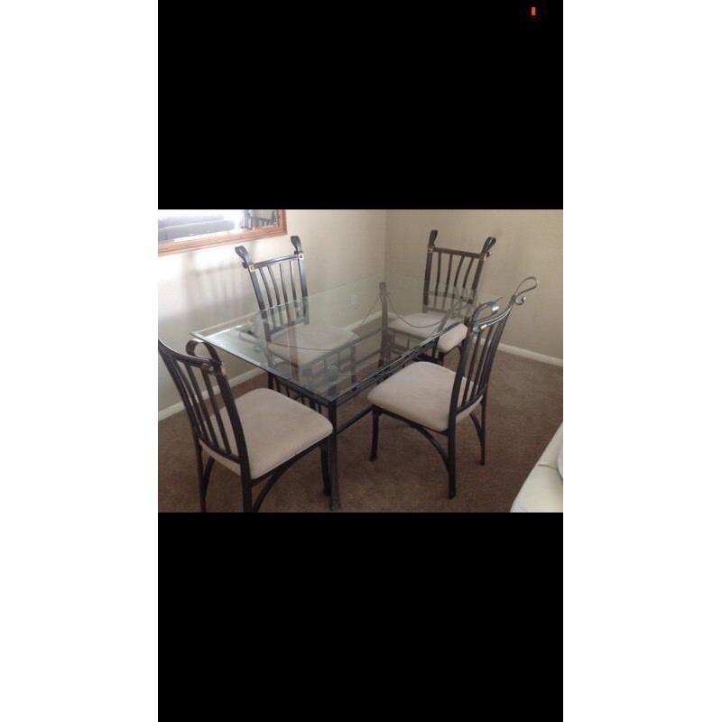 Glass dining table and four chairs