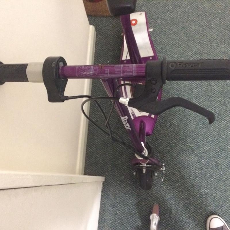 Electric razor scooter. Seat can be removed to stand up.