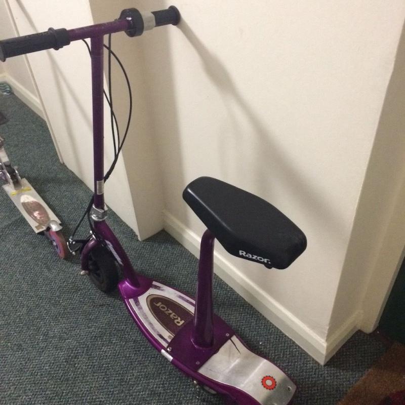 Electric razor scooter. Seat can be removed to stand up.