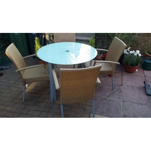 Glass Patio Table and 4 Stacking Rattan Chairs