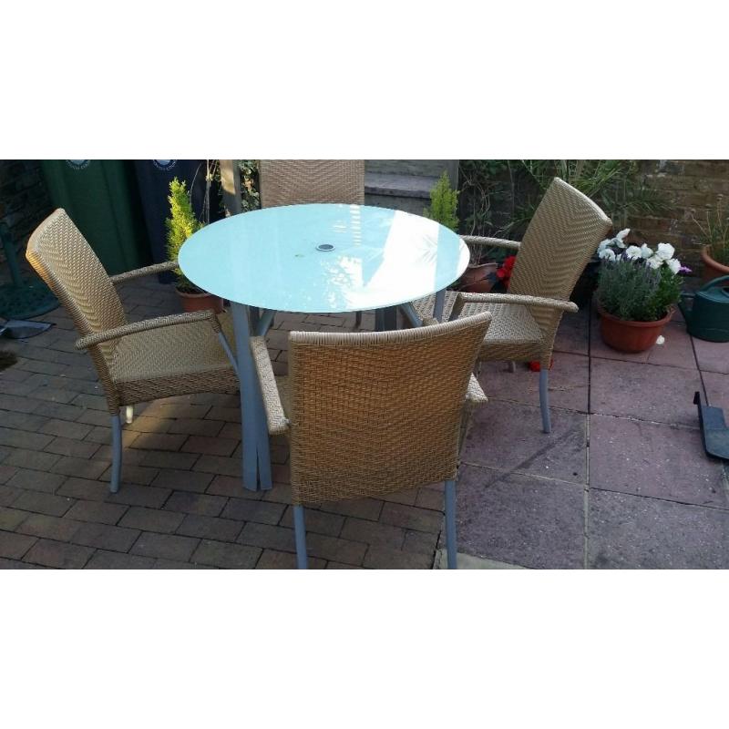 Glass Patio Table and 4 Stacking Rattan Chairs