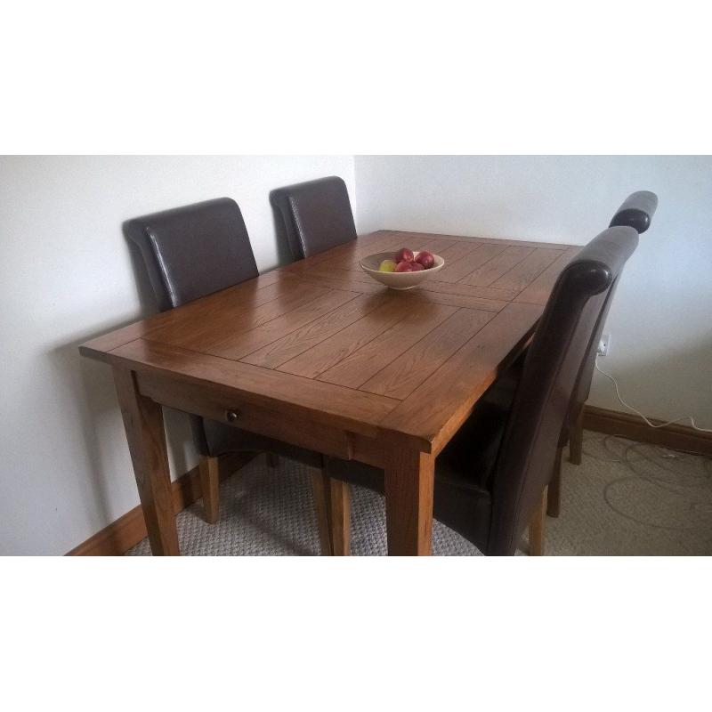 Extending Oak Dining Table and Four Brown Faux Leather Chairs