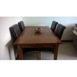 Extending Oak Dining Table and Four Brown Faux Leather Chairs