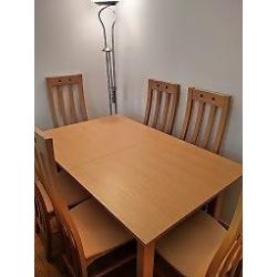 Extendable Diningroom table with 6 matching Chairs. 6-10 places. As New