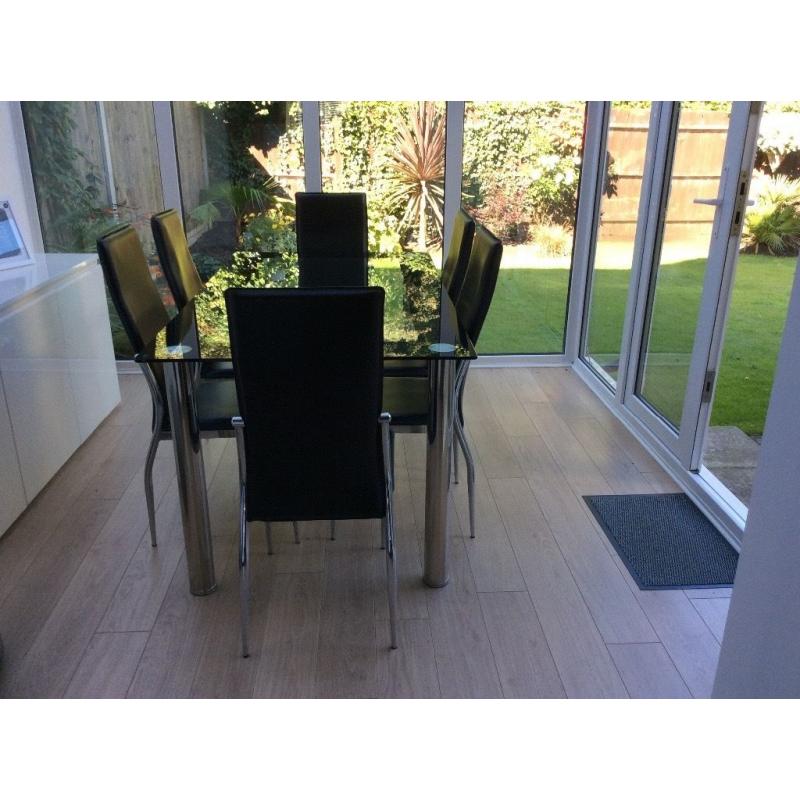Glass and chrome dining table and chairs