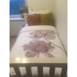 Single bed that slides into a double bed