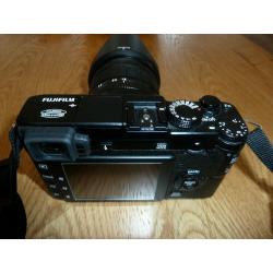 Fuji XE1 mirrorless compact with XF 18-55 lens plus extras.