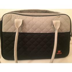 White and blue dog cararing bag