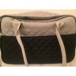 White and blue dog cararing bag