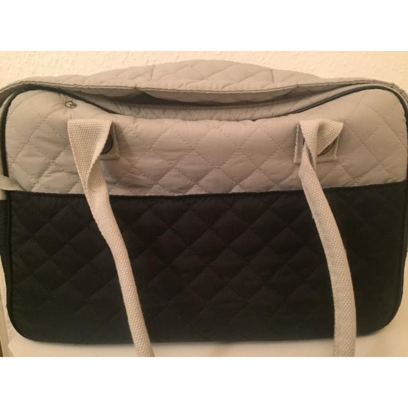 White and blue dog cararing bag