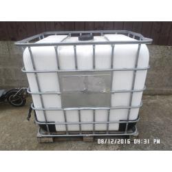 1,000 litre plastic tank in metal frame ,,,,