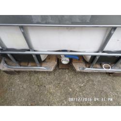 1,000 litre plastic tank in metal frame ,,,,