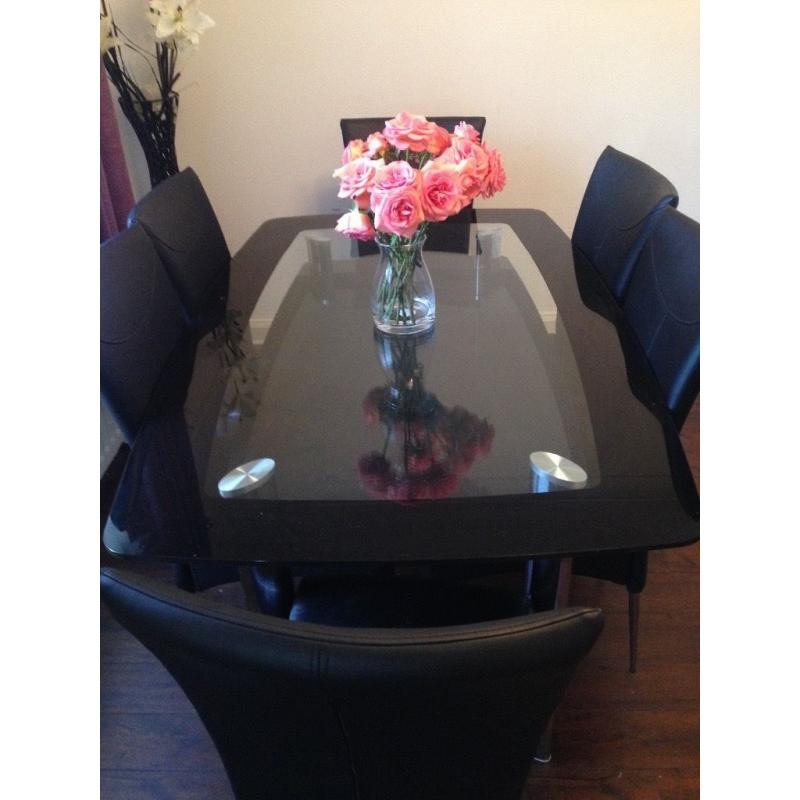 Black And clear glass dining table and chairs