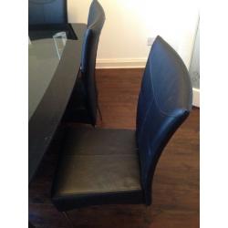 Black And clear glass dining table and chairs