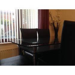 Black And clear glass dining table and chairs