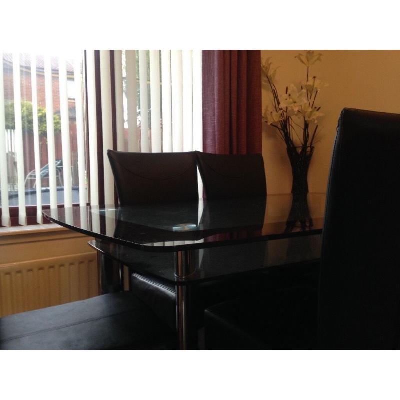 Black And clear glass dining table and chairs