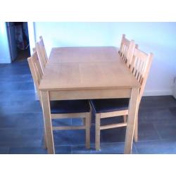 wooden dininig table and 4 chairs. Middle section to make table bigger also