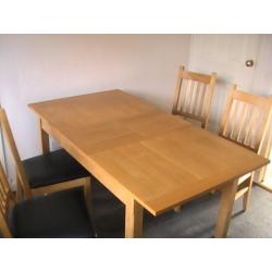 wooden dininig table and 4 chairs. Middle section to make table bigger also