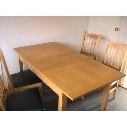 wooden dininig table and 4 chairs. Middle section to make table bigger also