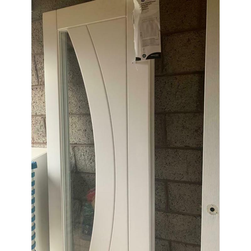 Xl joinery paired Salerno doors. White primed with clear glass