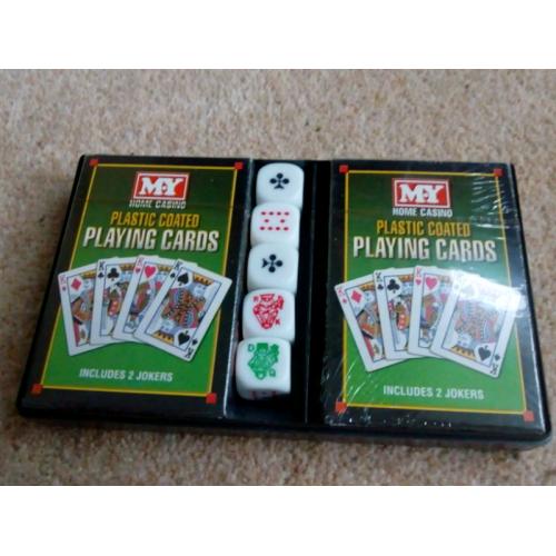 Two packs of playing cards still in cellophane and 5 dice
