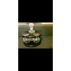 Decanter and 2 matching brandy glasses in dark wood display stand