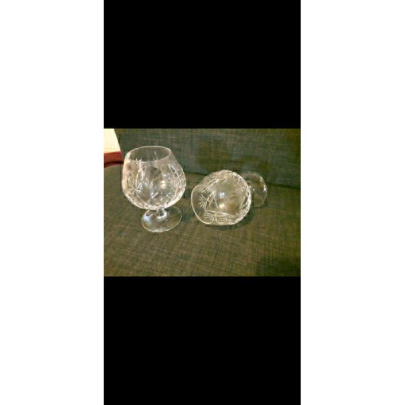 Decanter and 2 matching brandy glasses in dark wood display stand