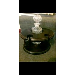 Decanter and 2 matching brandy glasses in dark wood display stand