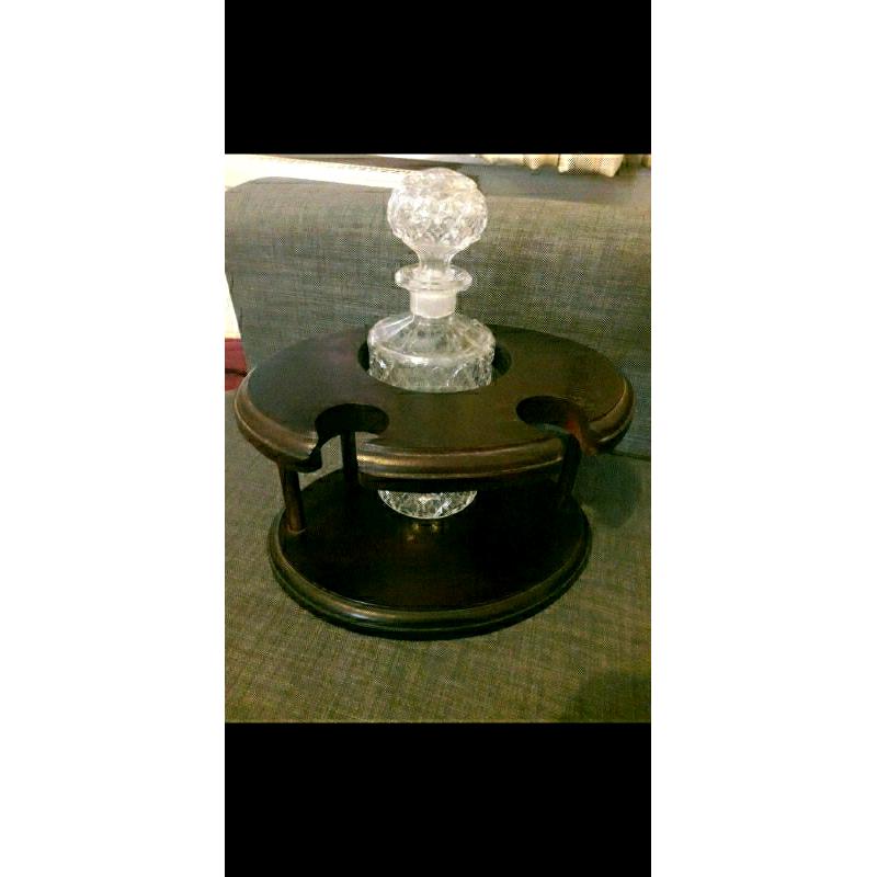 Decanter and 2 matching brandy glasses in dark wood display stand